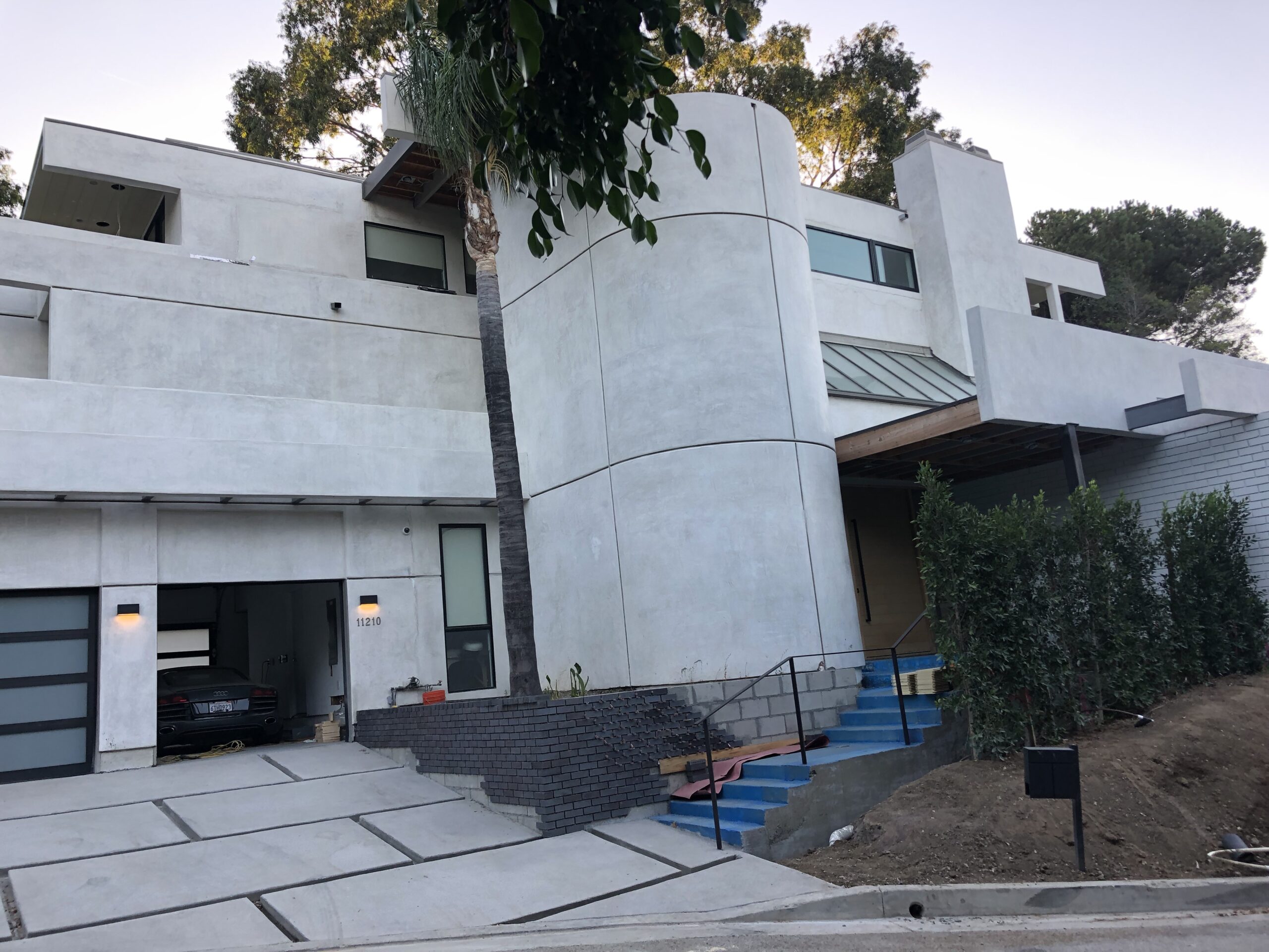 Modern white house with large windows.