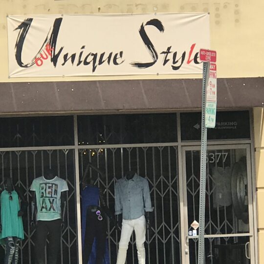 Storefront of Unique Style clothing shop with mannequins in casual wear. Storefront of Unique Style clothing shop with mannequins in casual wear.