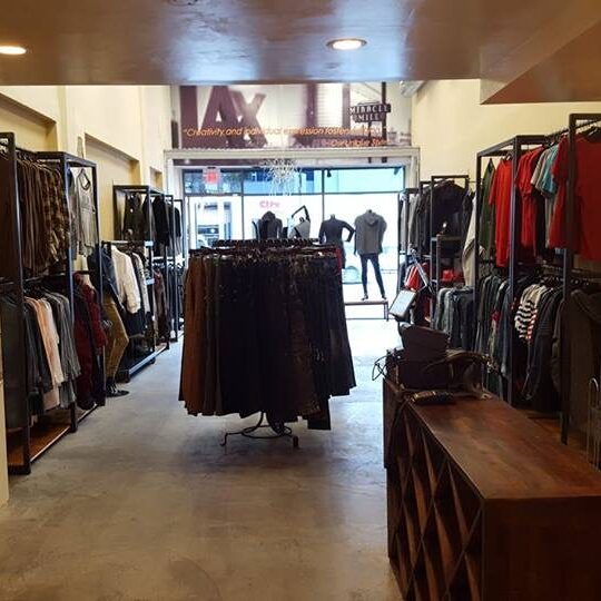 Interior view of a clothing store with racks and shelves. Interior view of a clothing store with racks and shelves.