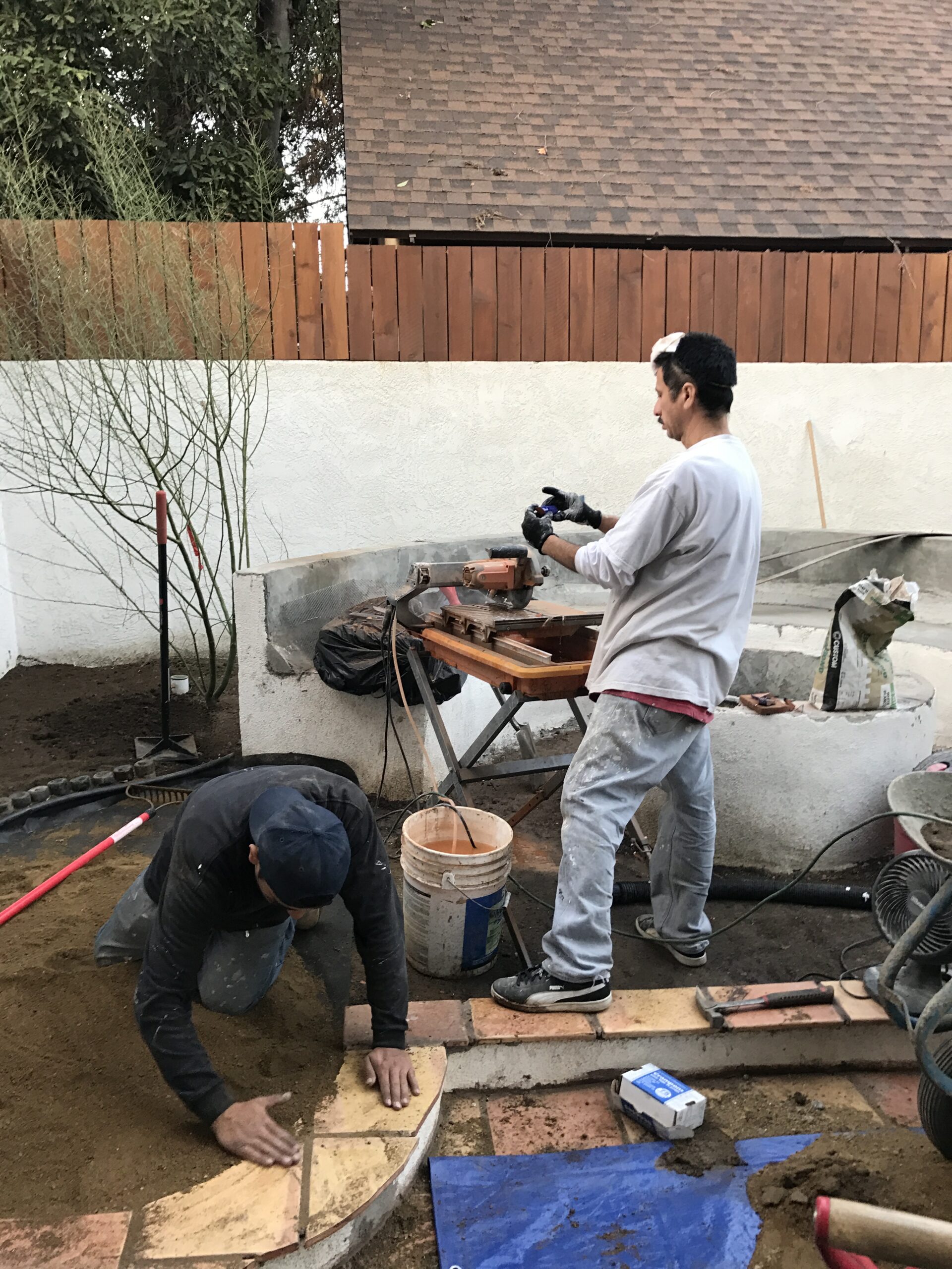 Two men working on a woodworking project outdoors.