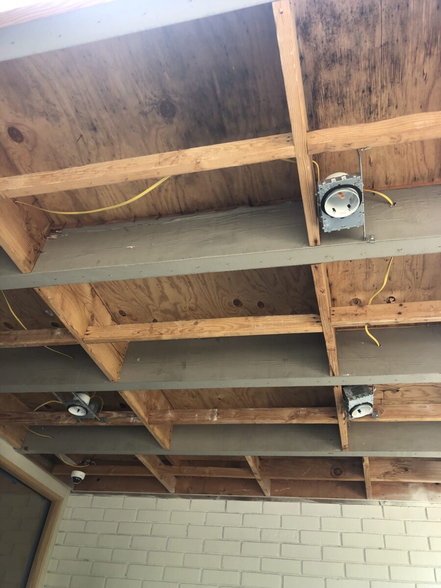 Exposed wooden ceiling with ductwork and smoke detectors. Exposed wooden ceiling with ductwork and smoke detectors.