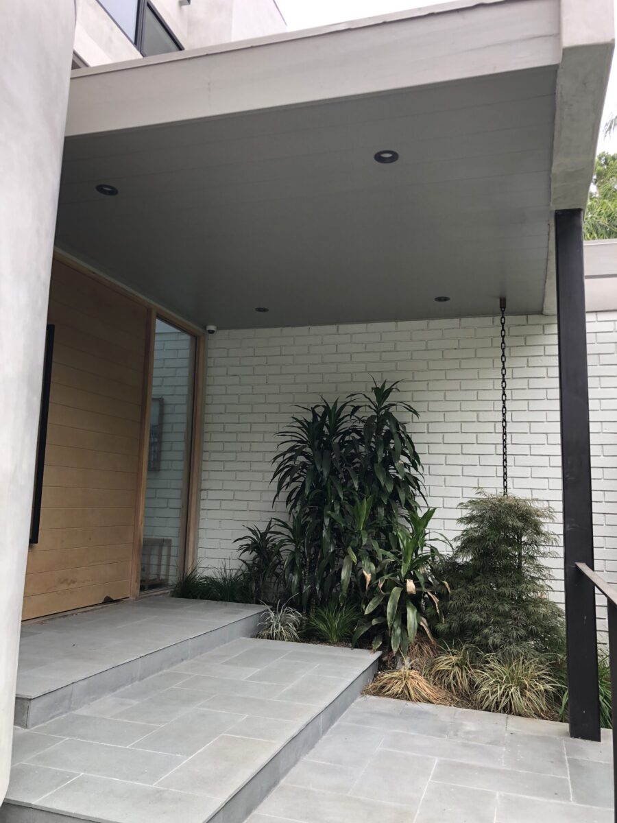 Modern entrance with white brick wall and plants. Modern entrance with white brick wall and plants.