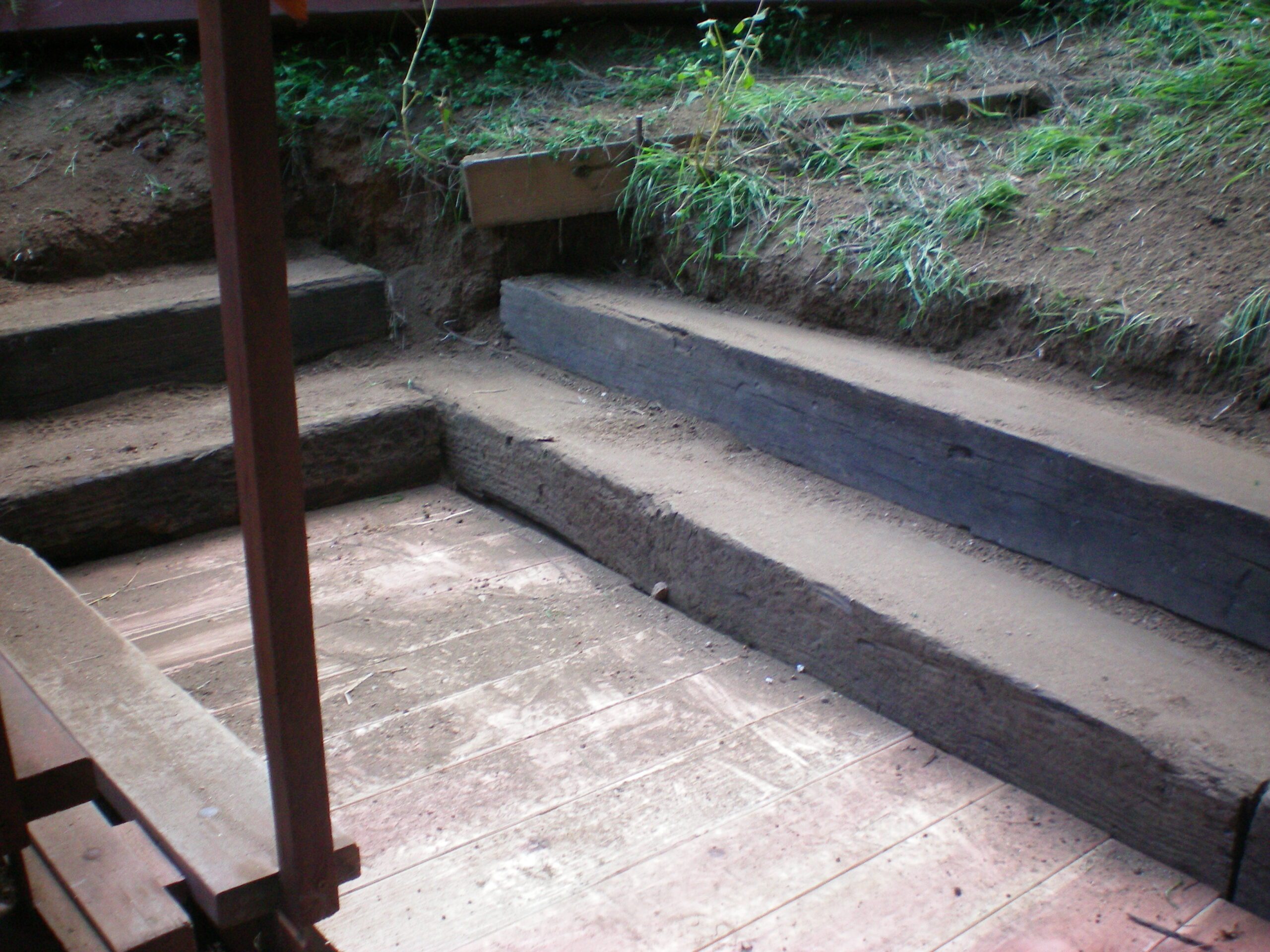 Wooden and dirt steps with grassy edges.
