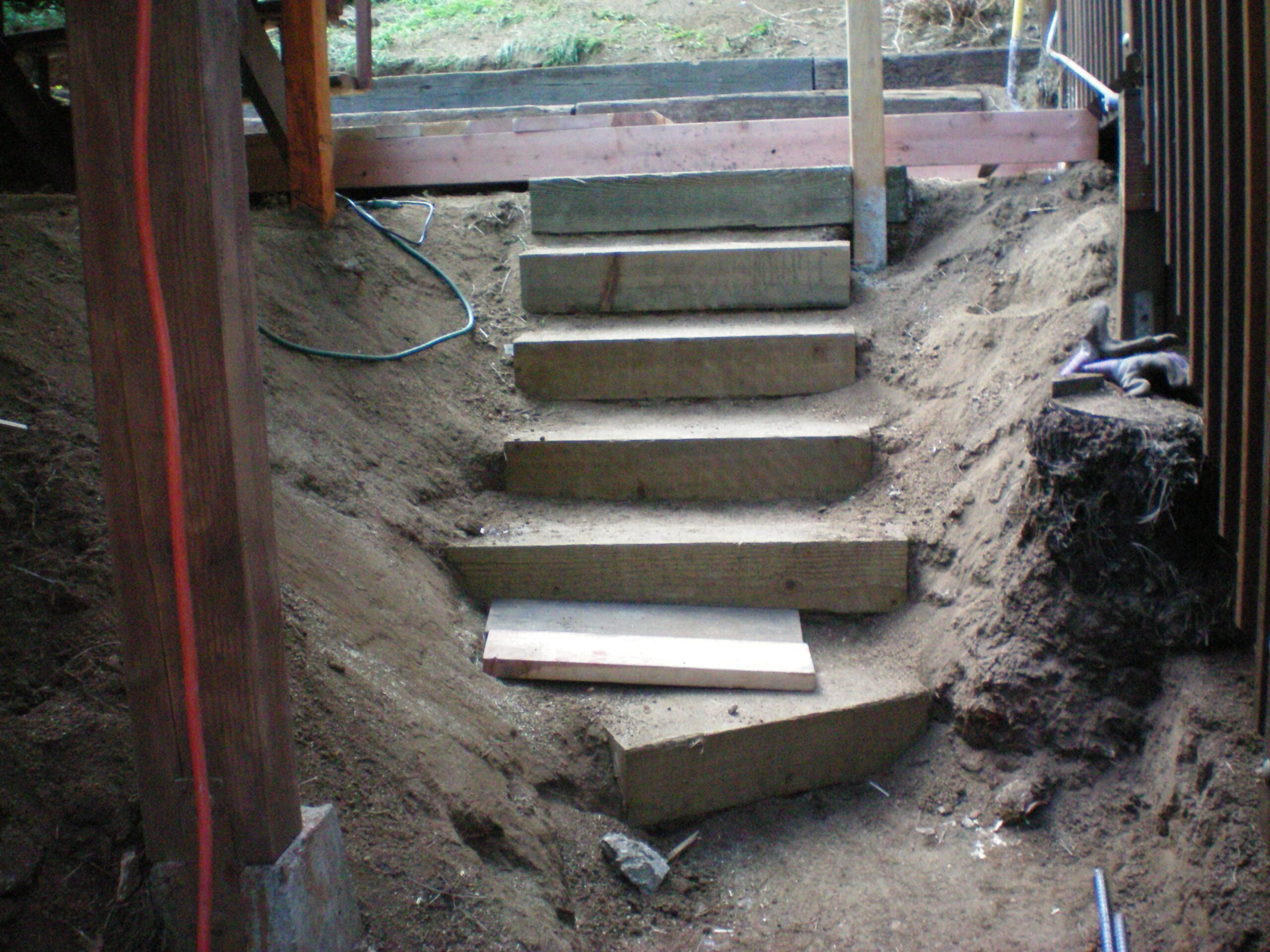 Wooden steps on a dirt slope.