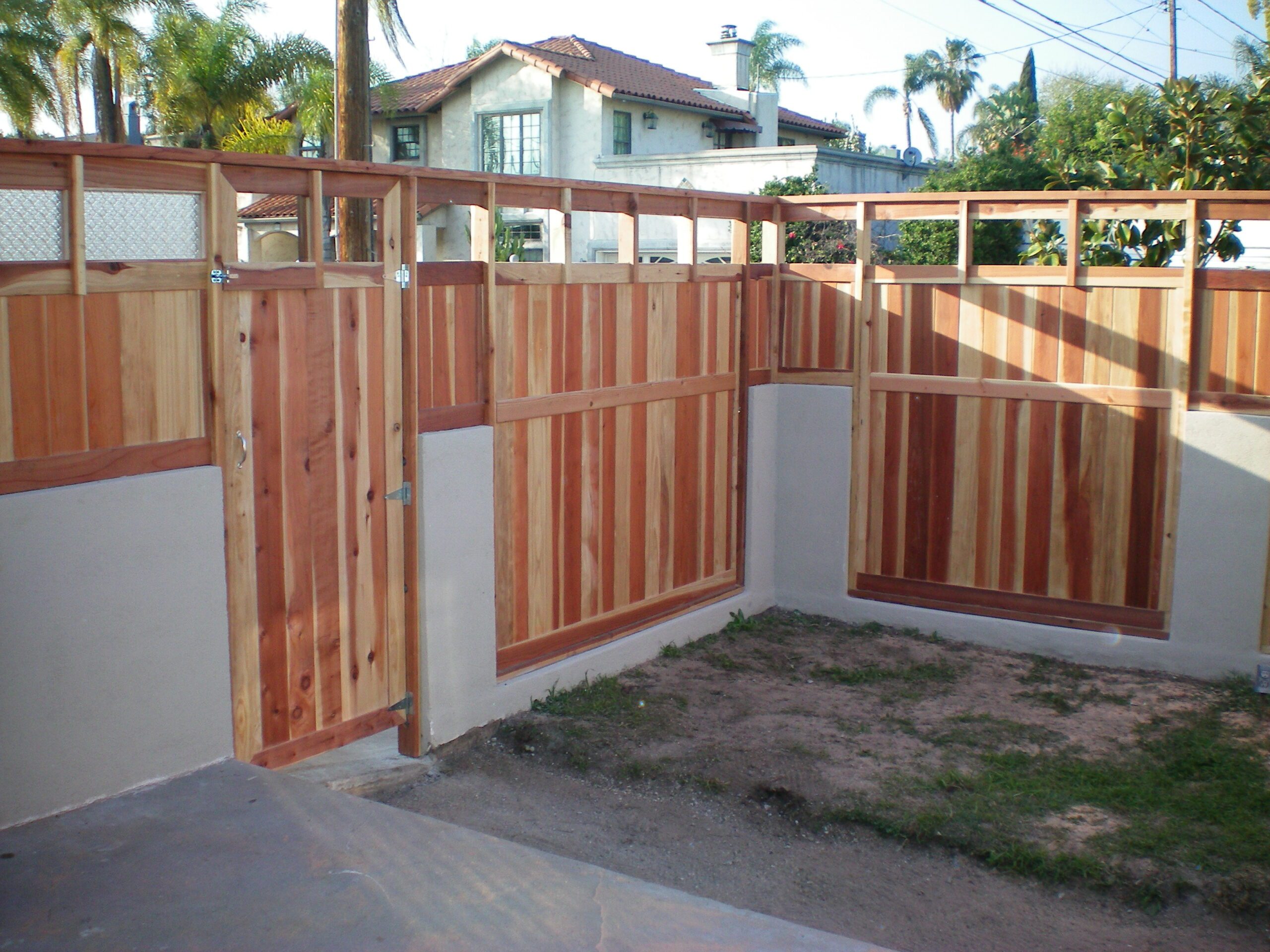 Wooden fence and gate in backyard.