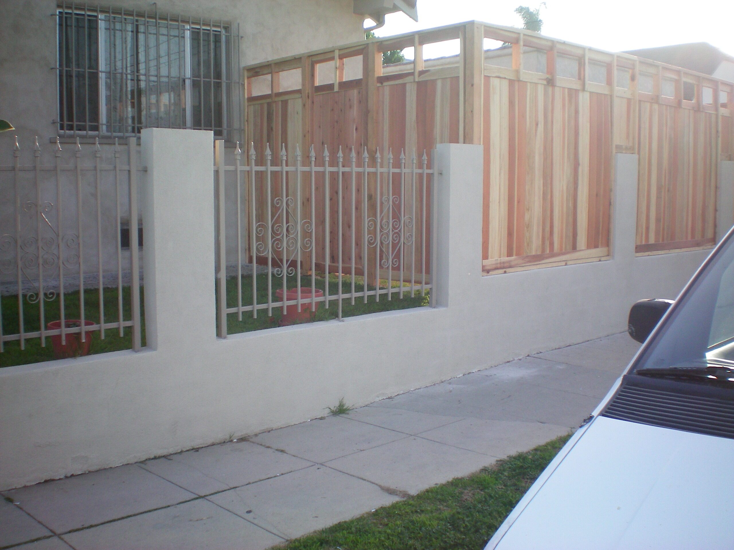 White fence and wooden construction near house. White fence and wooden construction near house.